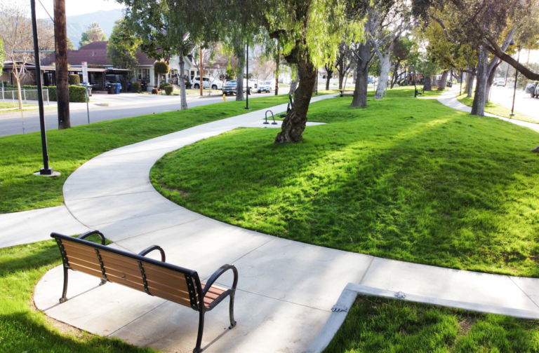 green grass surrounded by sidewalk