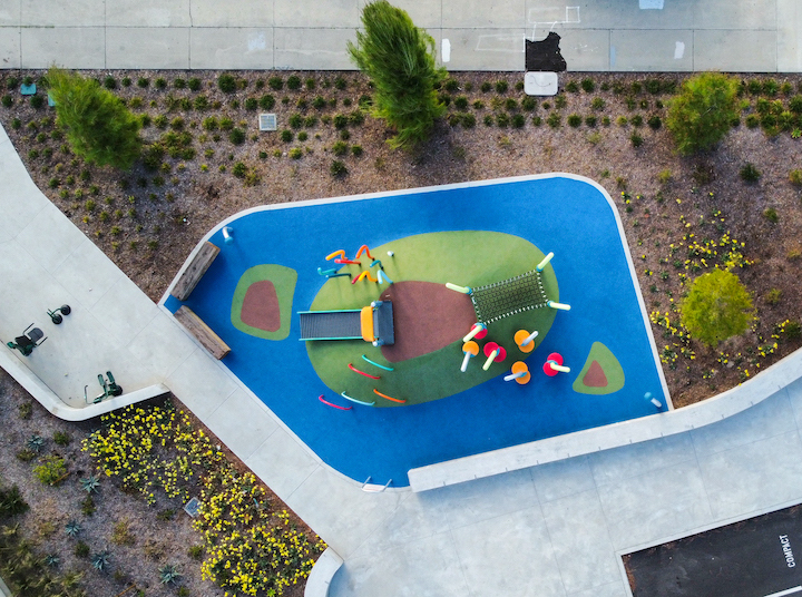 Greater Whittier Regional Aquatic Center playground with artificial turf