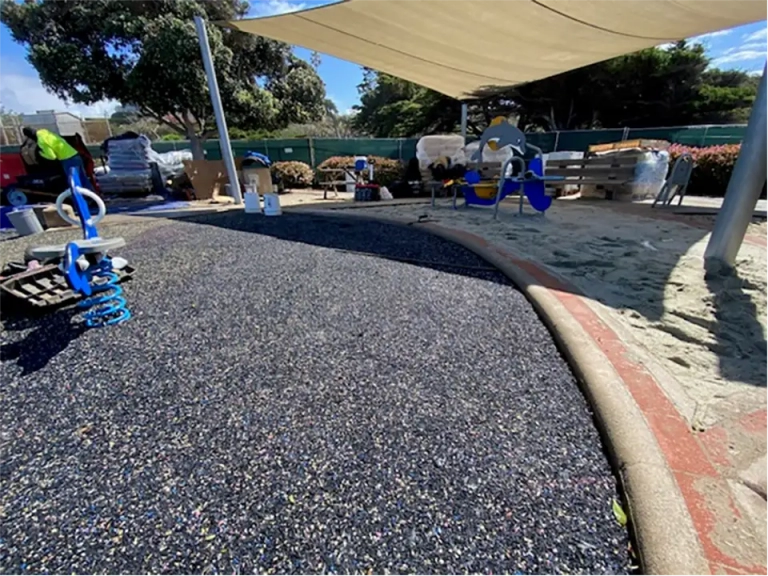 workers removing old playground surface