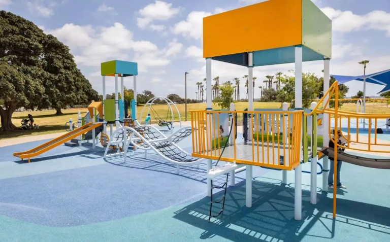 orange playground equipment on blue variant flooring