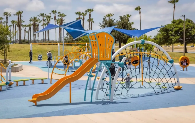 orange playground slide with climbing net