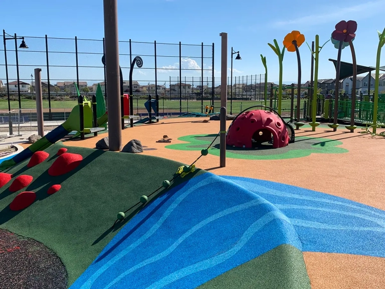 blue, green, and tan playground safety surfacing
