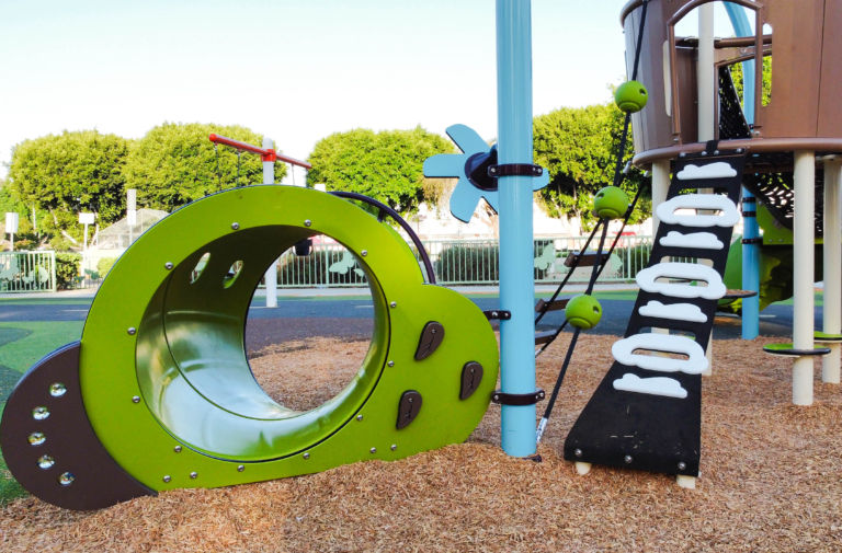 custom playground equipment in wood shavings